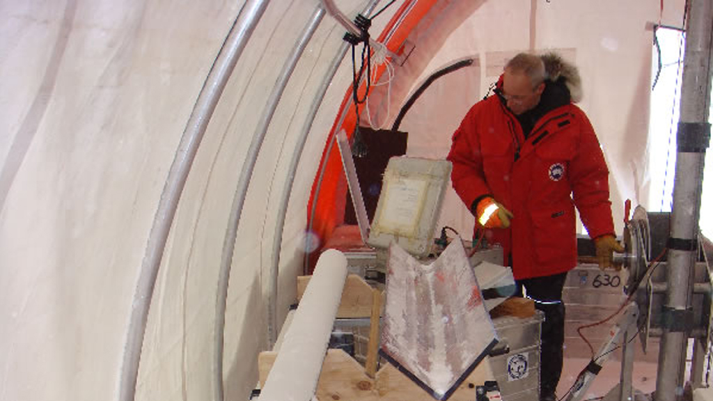A scientist studying an ice core exctracted from Law Dome glacier, Antarctica